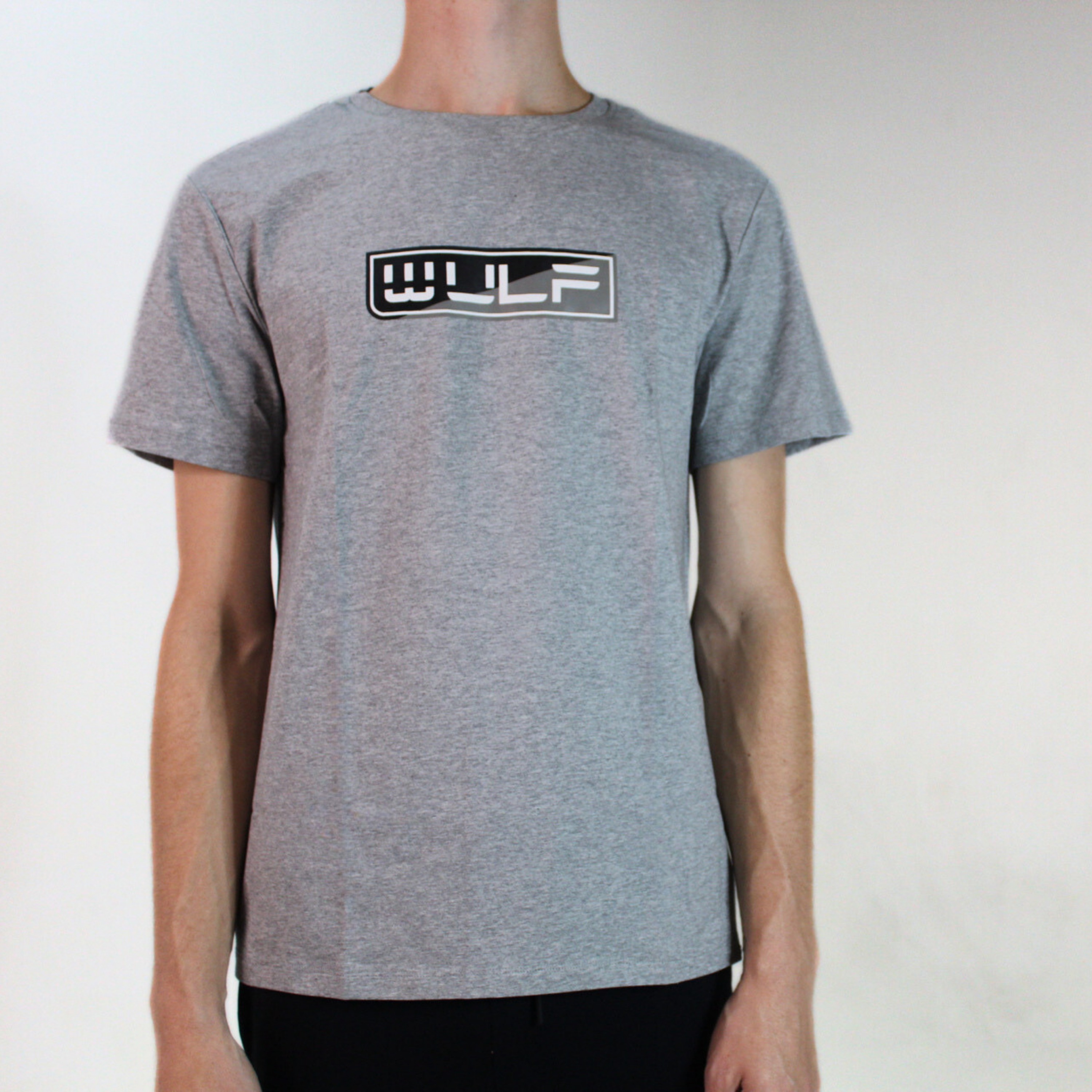 Expand your wardrobe with our Men's Gray Crew-Neck T-Shirt. Features black and white Wulf logo, back icon. Cotton and spandex where comfort meets distinction.